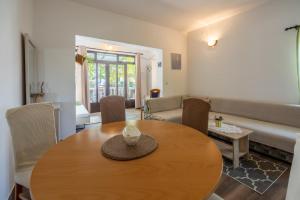 a living room with a table and a couch at Apartment Dom in Jadranovo +20 photos