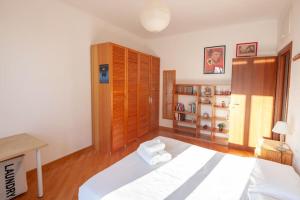 a bedroom with a large bed and a wooden cabinet at La Settima Arte - Milano Sarca in Milan