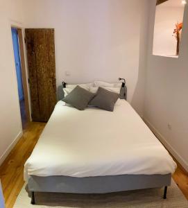 a bed with white sheets and pillows in a room at Heart of Lisbon Apartment in Lisbon