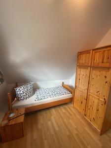 a bed in a room with wooden cabinets at Fehmarn 17-6 in Fehmarn