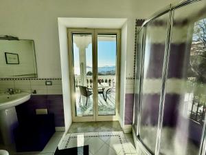 a bathroom with a shower and a glass door at B&B Dumbolo in Pozzuoli