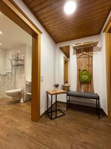 a bathroom with a toilet and a bench in a room at Appartement Krahlehen in Filzmoos