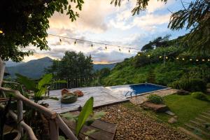 a backyard with a pool and a string of lights at Awesome Place in Ella