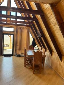 a dining room with a wooden table and chairs at Dilijan Gold Resort in Dilijan