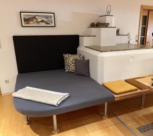 a blue bench in a kitchen with a counter at Apart Aria in Längenfeld