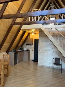 an attic room with a kitchen and a staircase at Dilijan Gold Resort in Dilijan