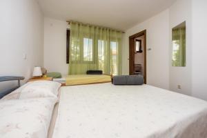 a bedroom with two beds and a window at Apartment Dom in Jadranovo