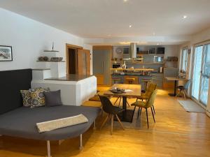 a living room and kitchen with a couch and a table at Apart Aria in Längenfeld