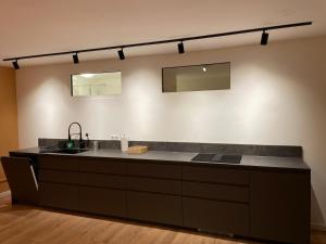 a kitchen counter with a sink and two mirrors at Lofts V26 in Essen