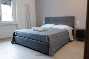 a bedroom with a bed with two towels on it at Elegant Apartments in Lugano in Lugano