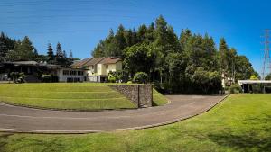 a house with a curvy road in front of a yard at Puri Setiabudhi in Bandung