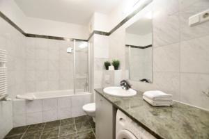 a white bathroom with a sink and a toilet at Standard Apartment by Hi5 - Kazinczy street in Budapest