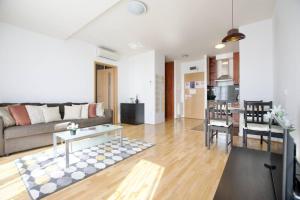 a living room with a couch and a table at Standard Apartment by Hi5 - Kazinczy street in Budapest