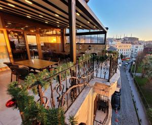 a balcony of a restaurant with a table and plants at Saruhan Hotel in Istanbul