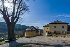 a house with a tree in front of it at Ekocentrum DOTEK in Horní Maršov