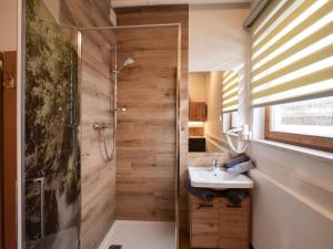 a bathroom with a shower and a sink at Appartement Musik-Neureiter in Söll