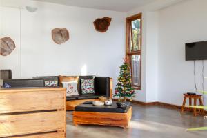 a living room with a christmas tree and a couch at Canto das Amêijoas in Inhambane