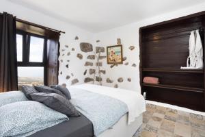 a bedroom with a bed and a piano at EK Las Vistas Finca el Milagro in La Orotava