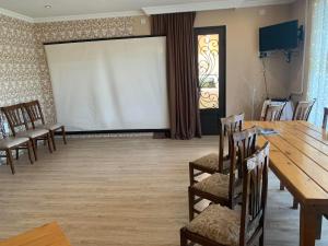 a conference room with a table and chairs and a projection screen at Nini's sweet house in Mat'khoji