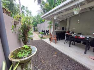 a patio with a table and a dining room at Sudu Guest in Habaraduwa Central