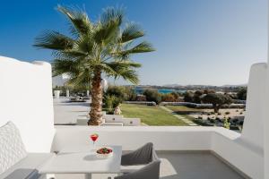 a palm tree on the balcony of a villa at White Dunes Luxury Boutique Hotel in Santa Maria