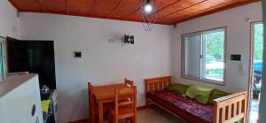 a living room with a couch and a window at Cabaña Claro de Luna in Merlo