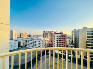 a view of a city from a balcony at Cozy 1 Bedroom apartment in Dubai by Al Ghaimah Holiday Homes in Dubai
