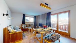 a living room with a table and a couch at Pracondu 1 301 - OUTDOOR & FUN apartment 6 pers in Nendaz