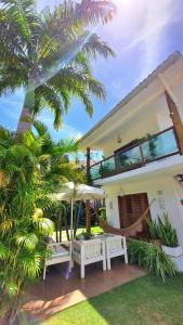 a house with a hammock in front of it at Vivenda Dias in Pipa