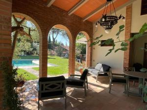 d'une terrasse avec des arches, une table et des chaises. dans l'établissement Le Balze Camere in Villa, à Pérouse