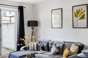 a living room with a gray couch and a window at Modern Bristol Abode - Parking and Garden in Bristol