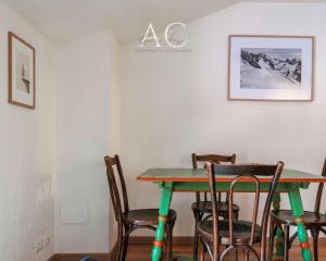 a dining room with a table and chairs at Square Apartment in Ponte di Legno