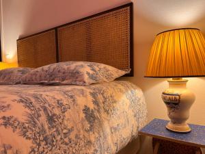 a bedroom with a bed with a lamp on a table at Garibaldina75 in Cesena