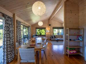 a dining room and living room with a table and chairs at Paddock House - Motueka Holiday Home in Motueka