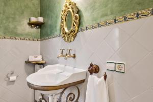a bathroom with a sink and a mirror at Casa María in Santa Maria del Camí +21 photos