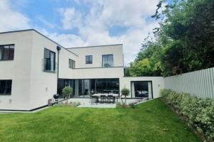 a white house with a green yard at Court House, Aldeburgh in Aldeburgh