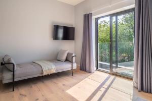 a living room with a couch and a large window at Court House, Aldeburgh in Aldeburgh