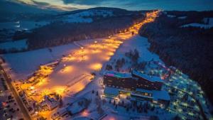 an aerial view of a ski resort in the snow at night at Apartamenty Wierch 17 in Kościelisko