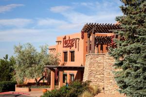 an orange brick building with a stone wall at The Lodge at Santa Fe in Santa Fe