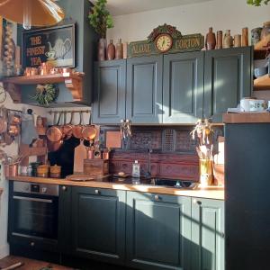 a kitchen with blue cabinets and a counter top at Le Banellou in Quimper