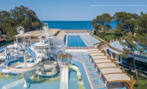 a large pool with a water park with a water slide at Baia Kemer Club in Beldibi