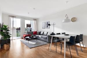 a living room with a couch and a table at Guestly Homes - 3BR Corporate Comfort in Boden