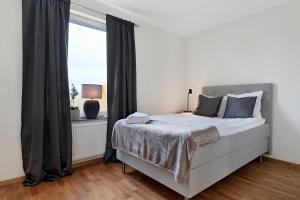 a bedroom with a bed and a large window at Guestly Homes - 3BR Corporate Comfort in Boden