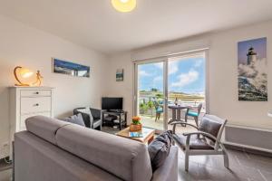 a living room with a couch and a table at résidence korejou plages in Plouguerneau