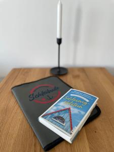 a book sitting on top of a wooden table at Schleibude in Schleswig