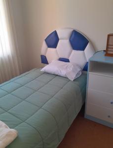 a bed with a large soccer ball on it at Las Mercedes in Arequipa