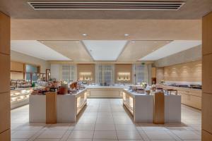 a large kitchen with white counters in a room at Hotel Caesius Thermae & Spa Resort in Bardolino