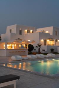 a villa with a swimming pool in front of a building at White Dunes Luxury Boutique Hotel in Santa Maria