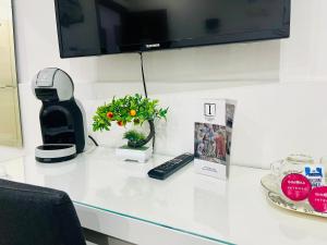 A television and/or entertainment centre at ImeraRooms