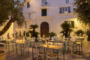 a courtyard with tables and chairs in front of a building at Santa Maria 24 in Monopoli